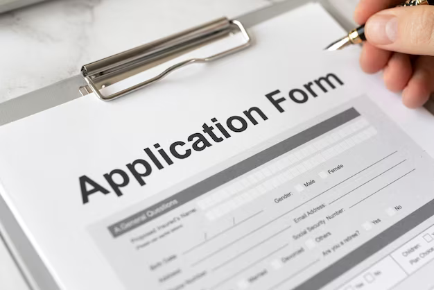 Close-up of a hand filling out a form